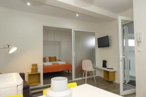 a room with a bedroom with a bed and a desk at A piece of paradise in the heart of Cascais in Cascais