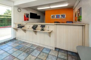 a waiting room with a counter and a tv at Motel 6-Sepulveda, CA - Los Angeles - Van Nuys - North Hills in North Hills