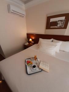 Postel nebo postele na pokoji v ubytování Porto Alegre Hotel