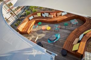 an overhead view of a deck with a couch and chairs at JO&JOE Paris - Nation in Paris