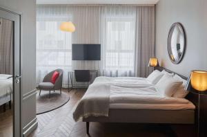 Кровать или кровати в номере Bergen Børs Hotel