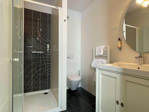 a bathroom with a toilet, sink, and shower at Best Western Plus Hotel Kregenn in Quimper