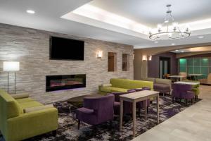 a lobby with couches and chairs and a fireplace at La Quinta by Wyndham Atlanta Stockbridge in Stockbridge