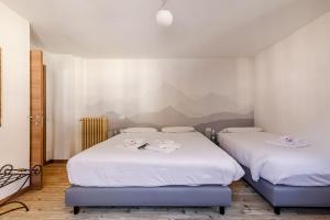 Postel nebo postele na pokoji v ubytování Hotel Dufour