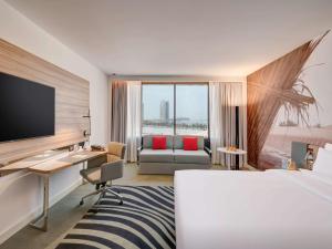 Кровать или кровати в номере Novotel Sharjah Expo Centre