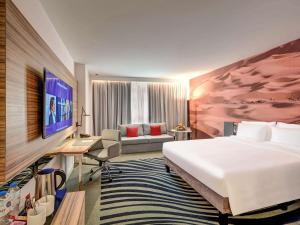 Кровать или кровати в номере Novotel Sharjah Expo Centre