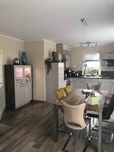 a kitchen and dining room with a table and chairs at Ferienhaus Villa Major in Göhren-Lebbin