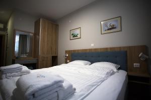 A bed or beds in a room at AquaSun Family Hotel