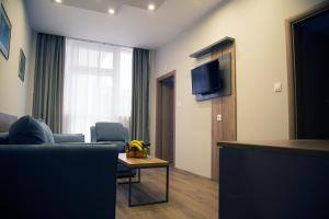 A television and/or entertainment centre at AquaSun Family Hotel