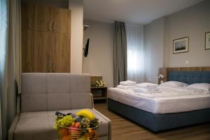 A bed or beds in a room at AquaSun Family Hotel