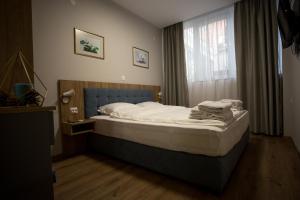 A bed or beds in a room at AquaSun Family Hotel
