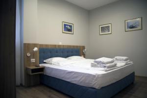 A bed or beds in a room at AquaSun Family Hotel