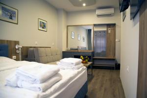 A bed or beds in a room at AquaSun Family Hotel