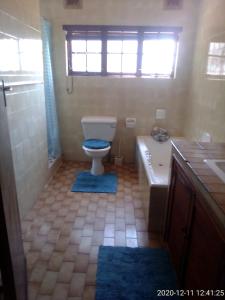 a bathroom with a toilet and a tub and a sink at Unit 6 Villa Marina in Hibberdene