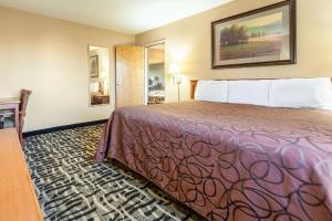 a hotel room with a bed in a room at Rodeway Inn Cozad in Cozad