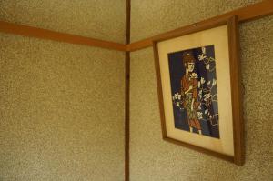 a picture hanging on the wall in a room at Guesthouse Ten-roku - Female Only in Osaka