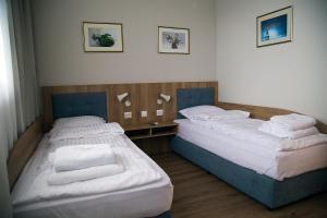 A bed or beds in a room at AquaSun Family Hotel