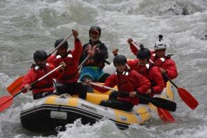a group of people in a raft in the water at Albturist Ecocamping Përmet & Outdoor Sports Center in Përmet