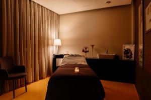 a hotel room with a bed, desk and lamp at Axis Viana Business & SPA Hotel in Viana do Castelo