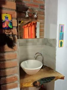 a bathroom with a white bowl sink on a counter at MONOAMBIENTES LOS SAUCES in Mina Clavero +41 photos