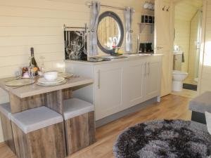 a bathroom with a vanity with a mirror and a sink at Stapeley Pod in Shrewsbury