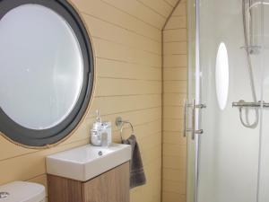 a bathroom with a sink and a mirror at Stapeley Pod in Shrewsbury
