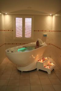 a baby laying in a bath tub in a bathroom at Cesar Thalasso in Midoun