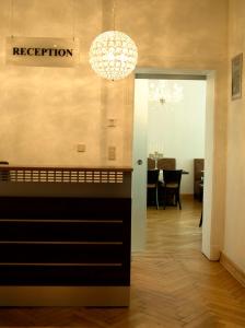 a living room with a chandelier and a dining room at Hotel Garni Kleist am Kurfürstendamm in Berlin