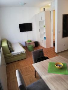 a living room with a table and a couch at Apartman Svetogorska in Zlatibor