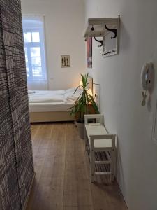 a room with a bed and a phone on the wall at 007 Studio Apartment Madrid 30m2 in Klagenfurt