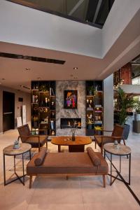 a living room with couches and a fireplace at Avantgarde Urban Sisli in Istanbul