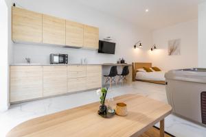 Il comprend une cuisine et un salon avec une table et un lit. dans l'établissement Love room Jacuzzi Sauna Privatif Marseille, à Marseille