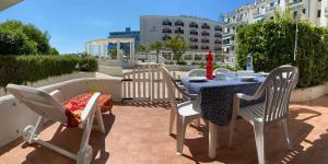 une table et des chaises assises sur une terrasse dans l'établissement RESIDENCE EL PALMAR FRONTE MARE, FRONTE SPIAGGIA (5 metri), FRONTE PISCINA (4 metri), à Lido di Jesolo