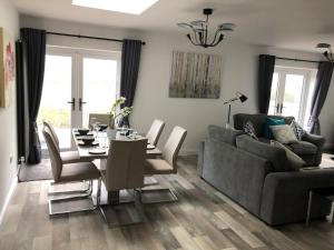 a living room with a dining table and a couch at 2 Barn Cottages in Whitchurch