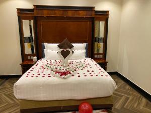a bedroom with a bed with a heart made out of roses at Makeen Homes by Warwick Hotel in Riyadh