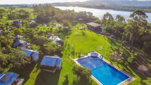 an aerial view of a house with a swimming pool at RANCHO COSTEIRO AGROTURSIMO E BALNEARIO E PESQUEIRO in Pôrto Xavier
