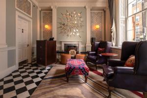 a living room with chairs and a fireplace at Home Grown - Private Member's Club in London