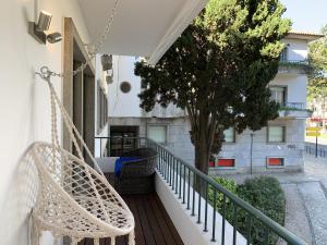 a balcony with two chairs and a tree at Cascais Downtown Premium Apt 3 with terrace in Cascais