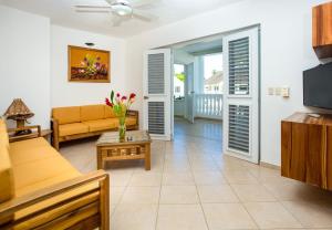 a living room filled with furniture and a tv at Albachiara Hotel - Las Terrenas in Las Terrenas