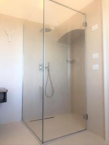 a shower with a glass door in a bathroom at Villa Torre Bianca by Emily Hotels in Polignano a Mare