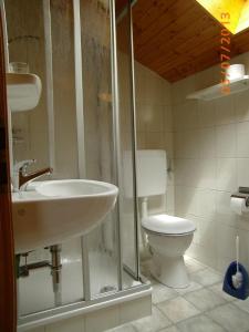 ein Bad mit einem Waschbecken und einem WC in der Unterkunft Haus Strobl in Gstadt am Chiemsee