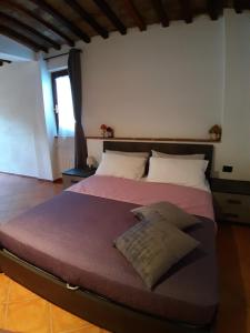 a large bed in a room with at La casa in giardino in Volterra