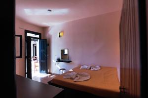 a bedroom with a bed with two towels on it at Little Lindos Sea View Studios in Líndos