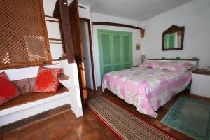 a bedroom with a bed and a green door at Townhouse Sleeps 6 with Private Pool in Gaucín +13 photos