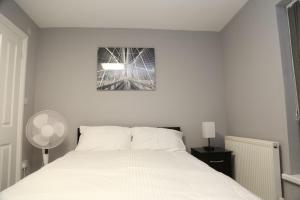 En eller flere senger på et rom på Budget 4-Bed House in Woolwich
