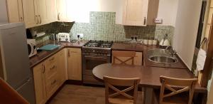 a kitchen with a sink and a stove top oven at Greater Manchester Immaculate Cozy Home in Oldham