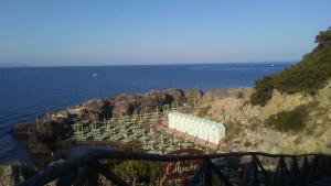 a group of containers on a cliff near the ocean at Casa vacanze mare blu in Talamone