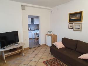 a living room with a couch and a flat screen tv at Apartma Cerknica in Cerknica