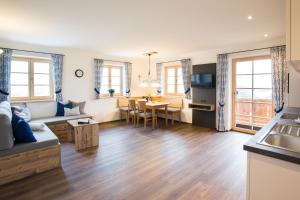 a living room with a couch and a table at Schleipfnerhof Urlaub auf dem Bauernhof in Bernau am Chiemsee