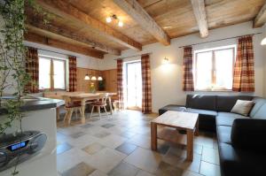 a living room with a couch and a table at Stöttnerhof Urlaub auf dem Bauernhof in Bernau am Chiemsee +13 photos